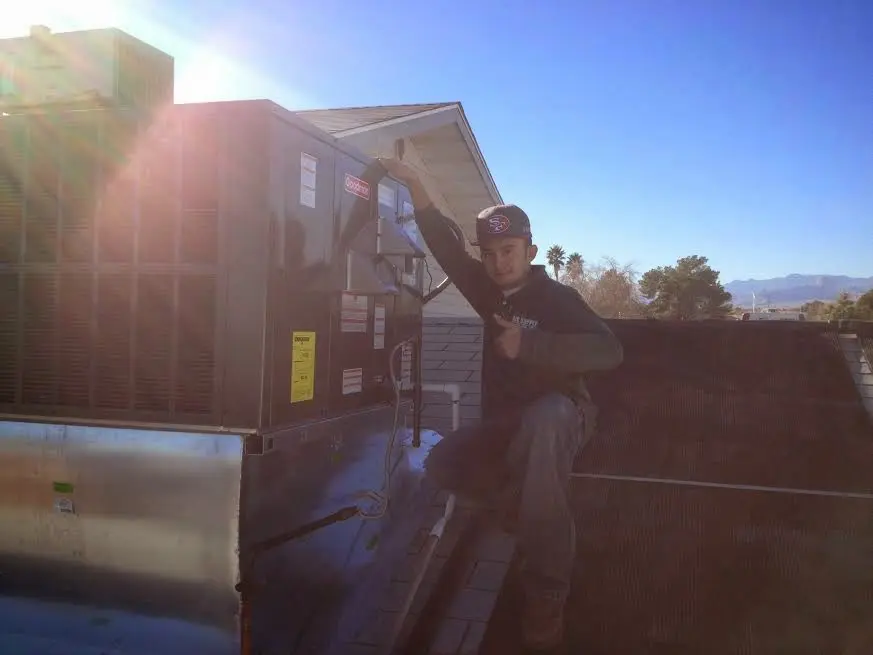 HVAC technician performing HVAC Inspection on a rooftop unit in Withamsville
